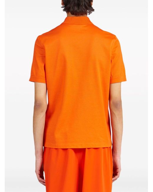 Polo à col zippé Ferragamo pour homme en coloris Orange