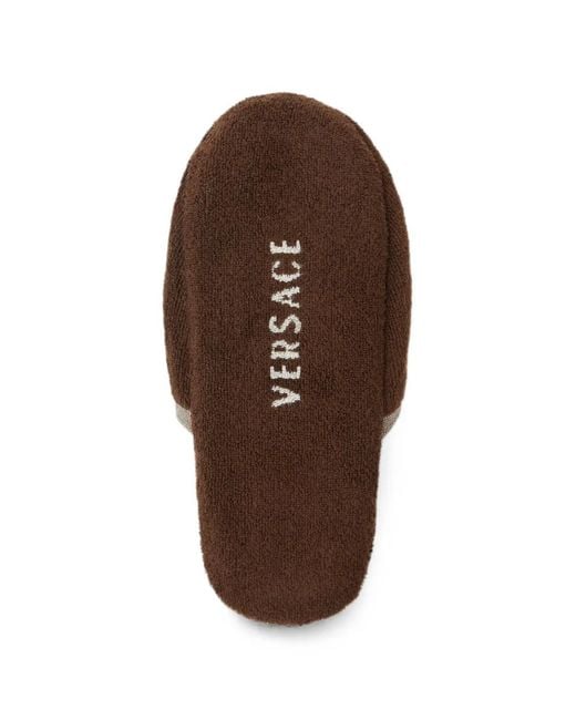 Slippers di Versace in Brown