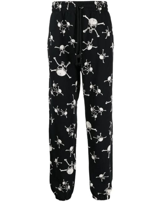 SAINT Mxxxxxx Black Skull-Print Cotton Track Pants for men