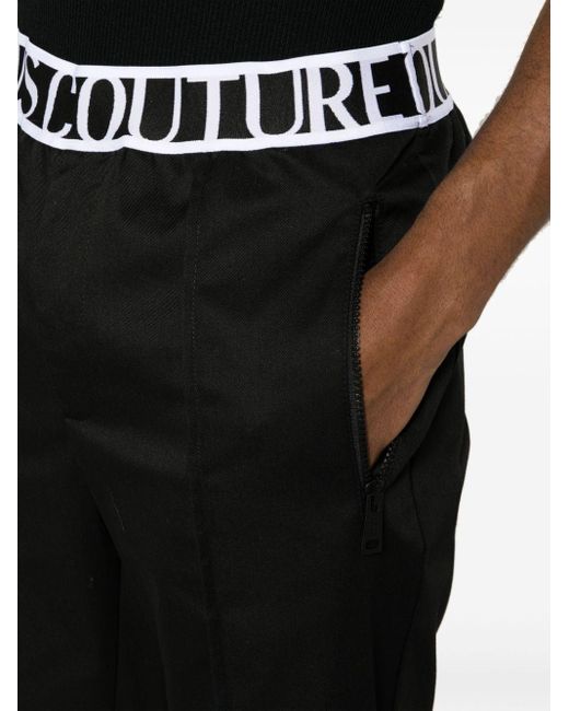 Pantalones con logo en la cinturilla Versace de hombre de color Black