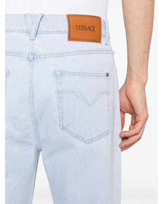 Jean droit à patch logo Versace pour homme en coloris Blue