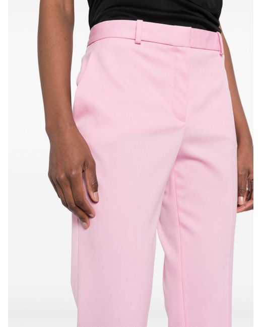 Pantalon fuselé à plis marqués Versace en coloris Pink