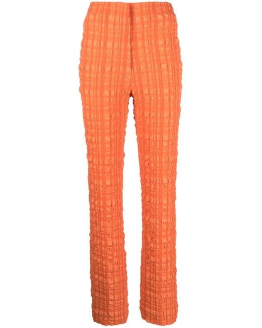 Pantalones de tejido seersucker Juna Nanushka de color Orange