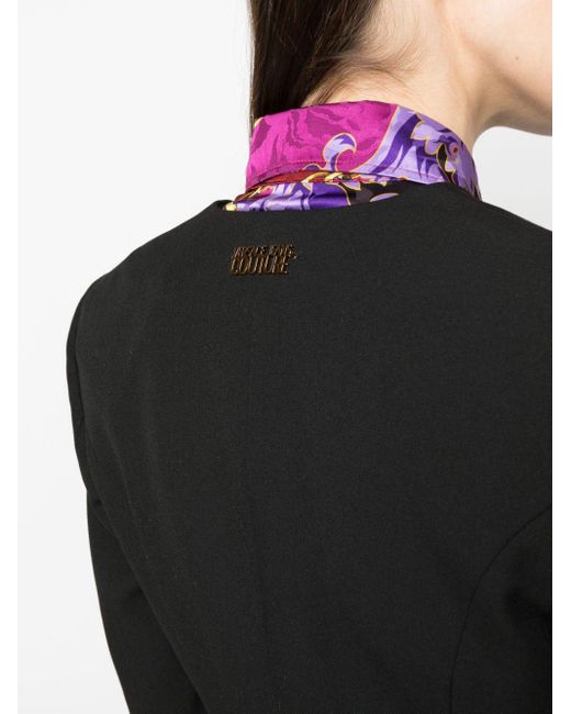 Blazer boutonné à découpes Versace en coloris Black