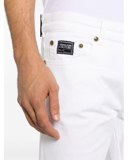 Jean slim à patch logo Versace pour homme en coloris White