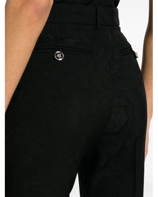 Pantaloni svasati di Versace in Black
