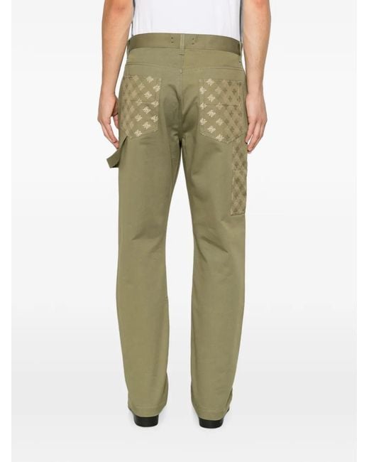 Amiri Green Monogram-Pattern Panelled Trousers for men