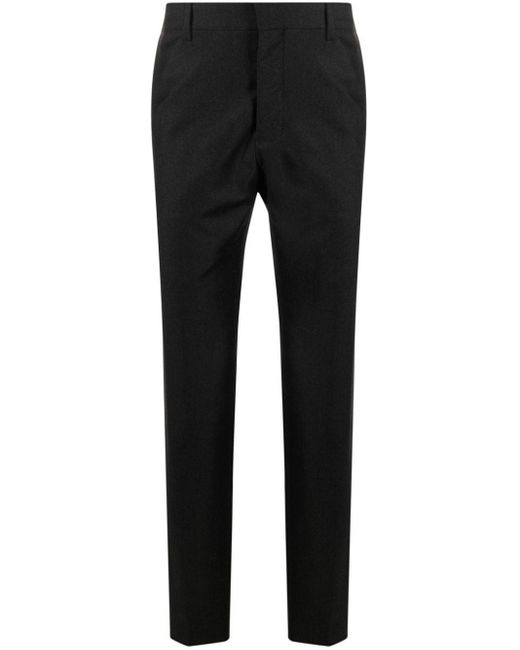 Tapered-leg wool trousers di AMI in Black da Uomo