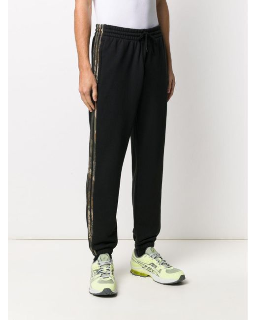 black tracksuit bottoms with white stripe