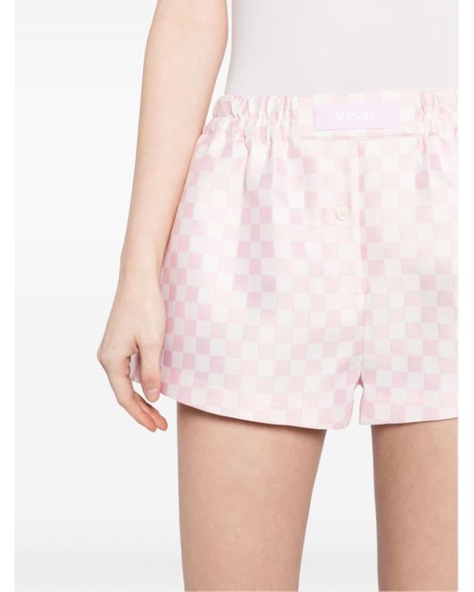 Checked logo-appliqué shorts di Versace in Pink