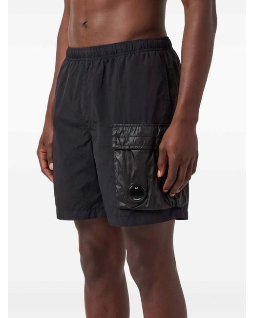 C P Company Black Rente Wrinkle Nylon Swim Shorts With Leg Pocket With Lens Detail.<Br for men