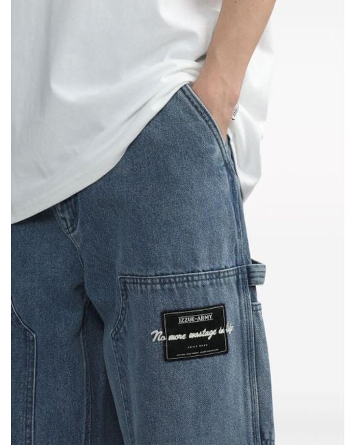 Jeans a gamba ampia con applicazione di Izzue in Blue da Uomo