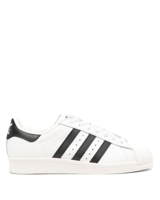 Adidas white shoes sales with black lines