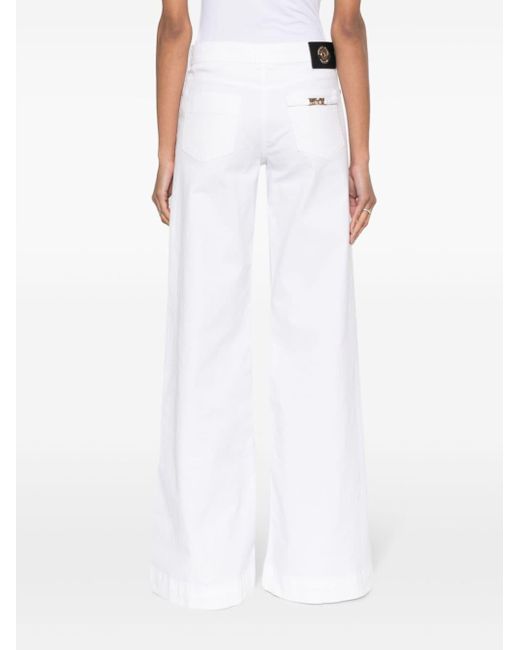 Jean ample à patch logo Versace en coloris White