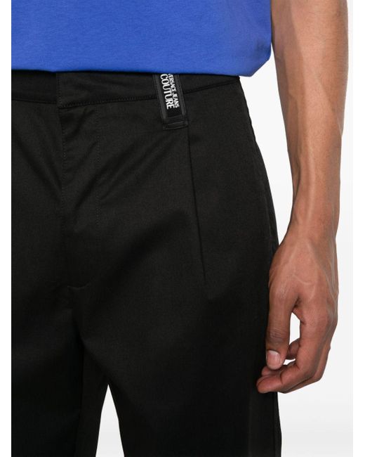 Pantalones con aplique del logo Versace de hombre de color Black