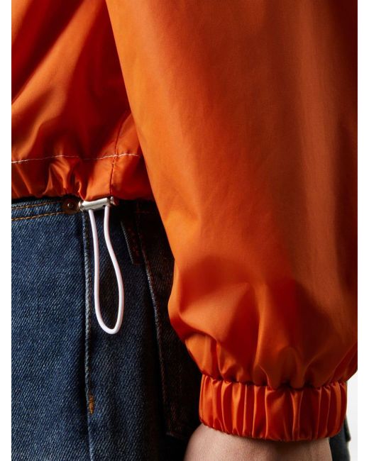 Cortavientos con capucha y paneles Hogan de color Orange