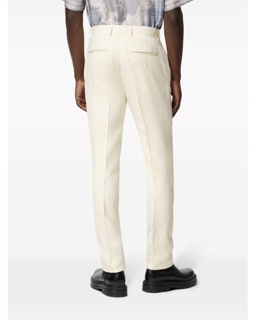 Pantalones de vestir lisos Versace de hombre de color White