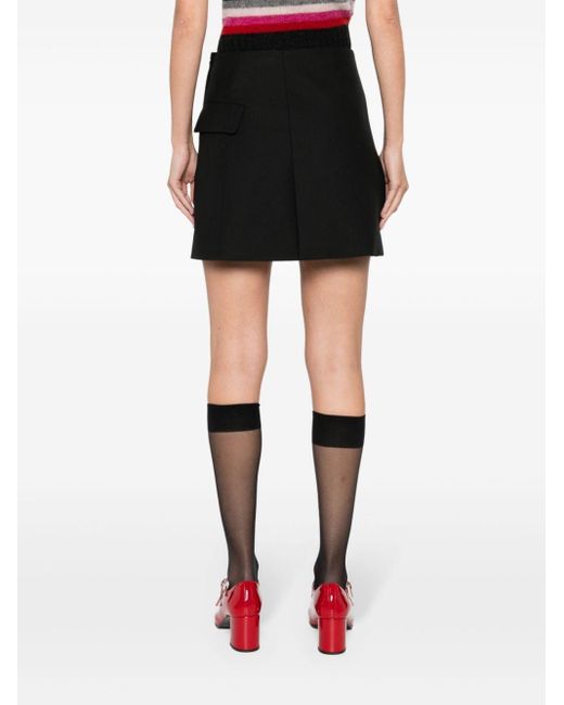 Minifalda cruzada asimétrica Maje de color Black