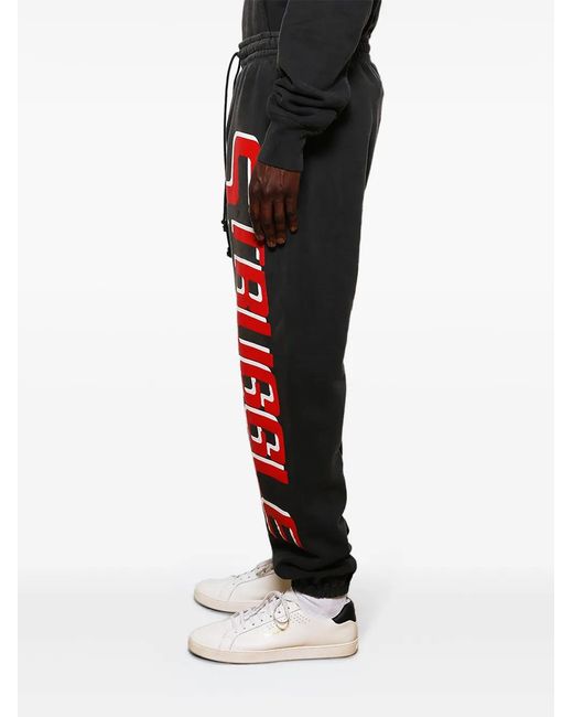 SAINT Mxxxxxx Black Logo-Print Cotton Track Pants for men