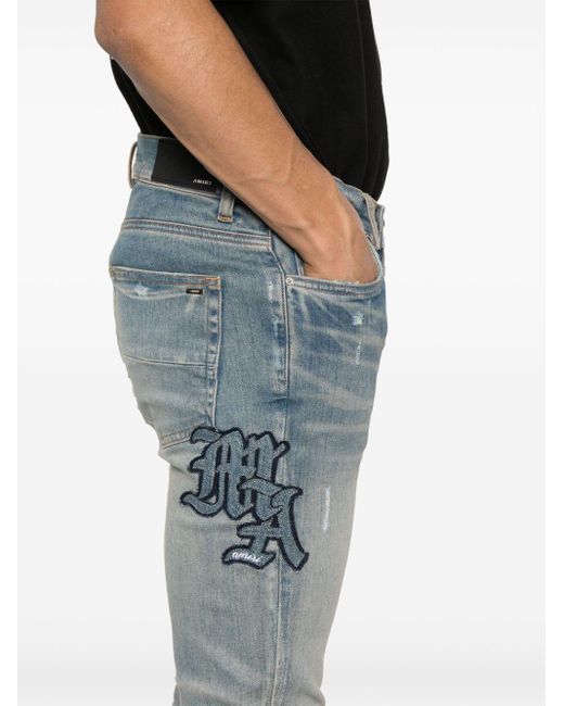 Amiri Blue Logo-Patch Ripped Skinny Jeans for men
