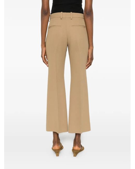 Totême Natural Kick Pressed-Crease Flared Trousers