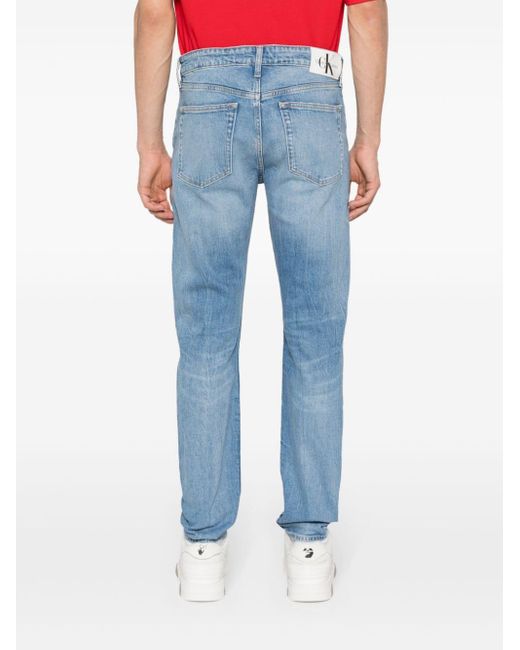 Jeans affusolati con effetto vissuto di Calvin Klein in Blue da Uomo