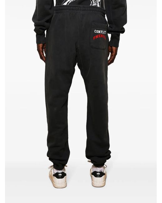 SAINT Mxxxxxx Black Logo-Print Cotton Track Pants for men