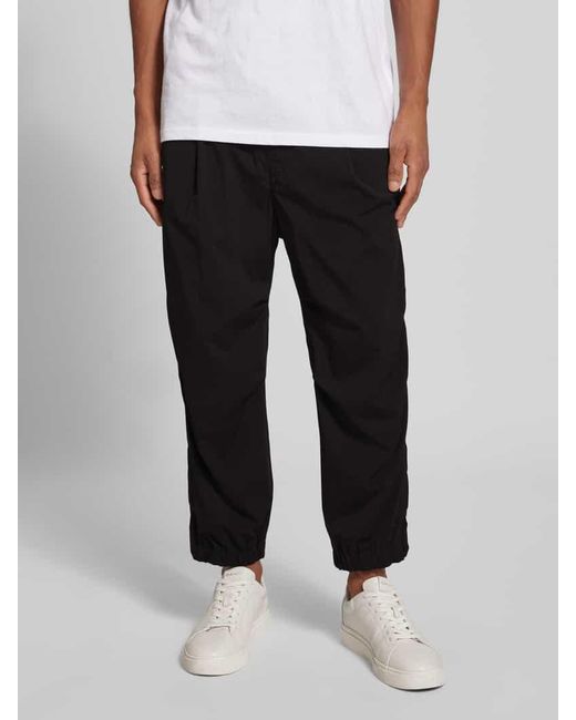 Drykorn Tapered Fit Bundfaltenhose mit elastischem Bund in Black für Herren