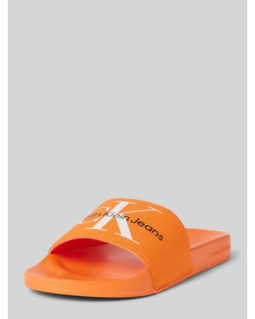 Calvin Klein Slides mit Label-Print Modell 'MONOGRAM' in Orange für Herren
