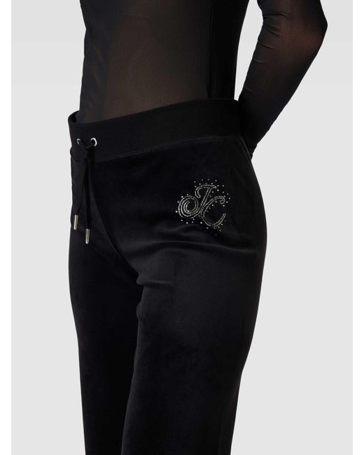 Juicy Couture Black Trackpants mit ausgestelltem Schnitt Modell 'SCATTER DIAMANTE'