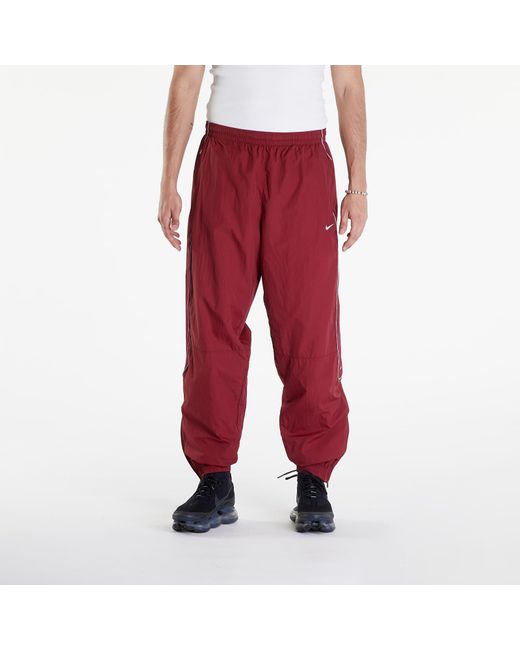 Solo swoosh track pants team red/ white di Nike da Uomo