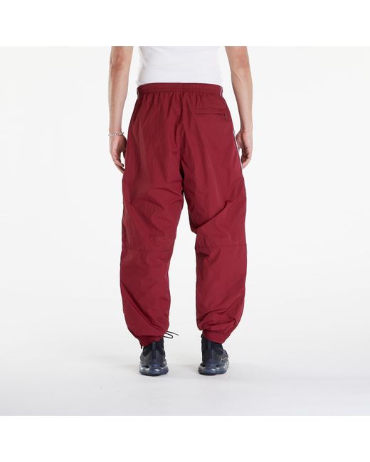 Solo swoosh track pants team red/ white Nike pour homme