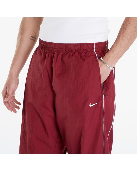 Solo swoosh track pants team red/ white Nike pour homme