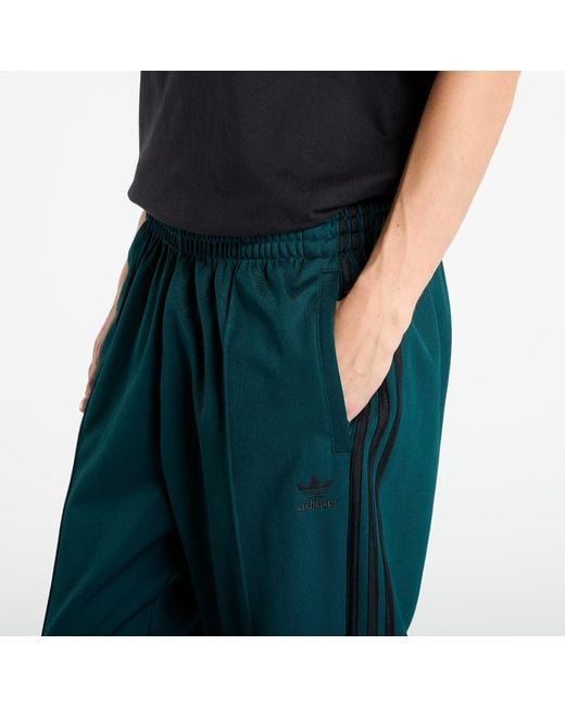 Adidas Originals Green Pants Adidas Adicolor Baggy Fit Firebird Track Pants Aurora Ivy for men