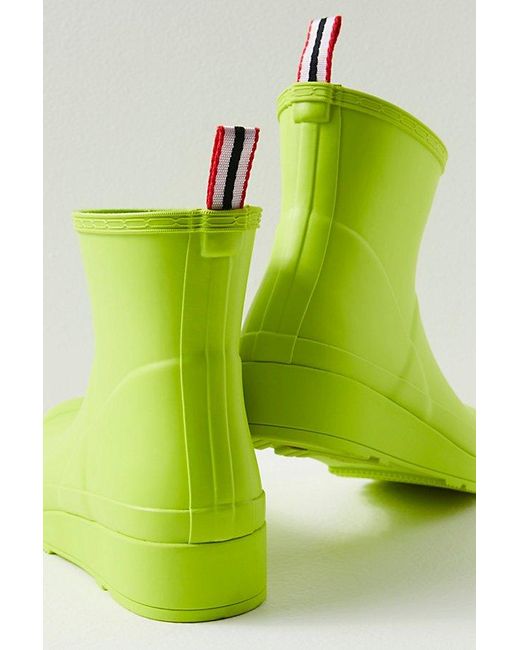 Hunter Play Short Wellies At Free People In Acid Green, Size: Us 8