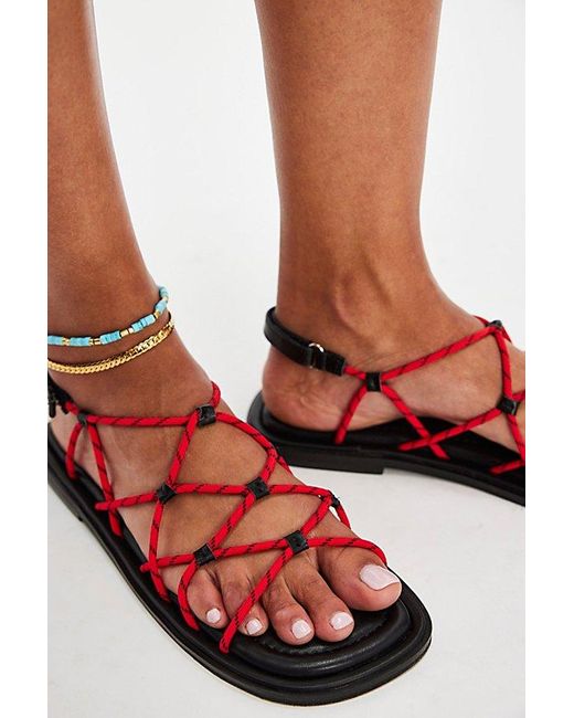 INTENTIONALLY ______ Red Bungee Strappy Sandals By
