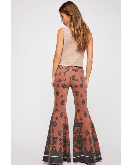 Free People Just Float On Printed Flare Jeans By We The Free in Orange