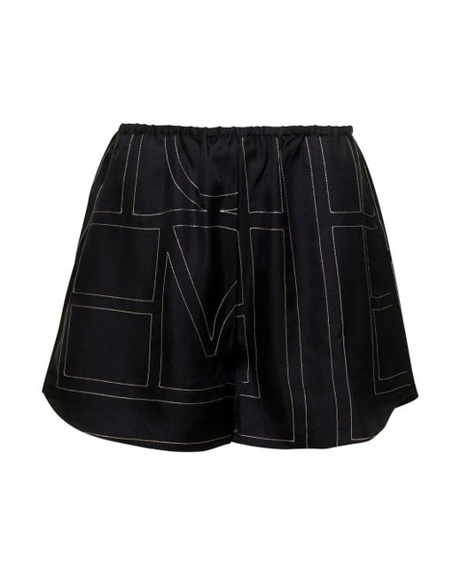 Pantaloncini Shorts Con Stampa Logo All-Over Neri di Totême  in Black