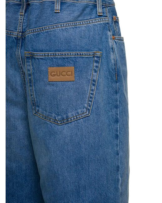 Jeans a cinque tasche dritti con patch logo in denim di cotone azzurro di Gucci in Blue
