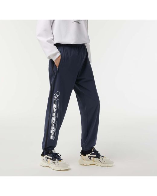 Lacoste Showerproof Stretch Track Pants in Blue for Men Lyst UK