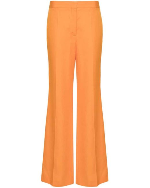 Pantaloni svasati a vita media di Stella McCartney in Orange