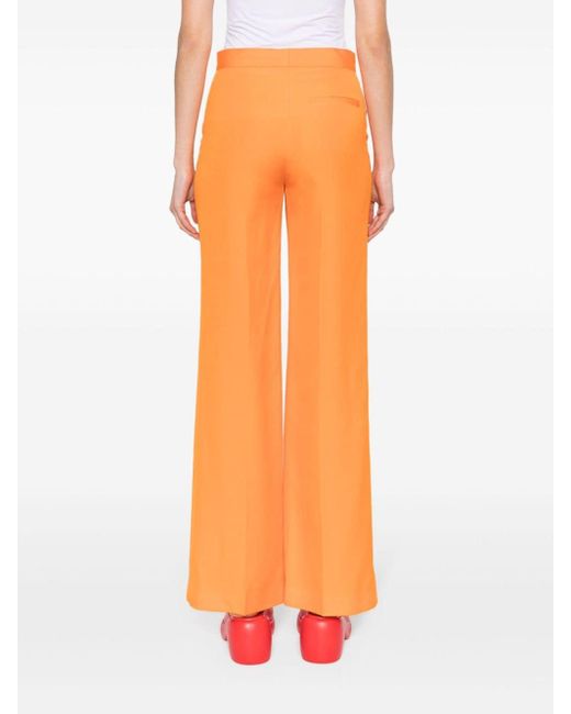 Pantaloni svasati a vita media di Stella McCartney in Orange