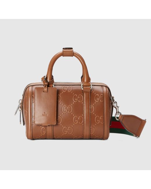 Gucci Mini-Reisetasche aus geprägtem GG Leder in Brown für Herren