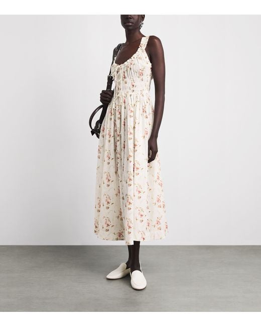 doen emmaretta dress The Emmaretta midi dress by Den promising a lovely summer showcases the full poetry of a floral print on a light Doen Emmaretta Dress