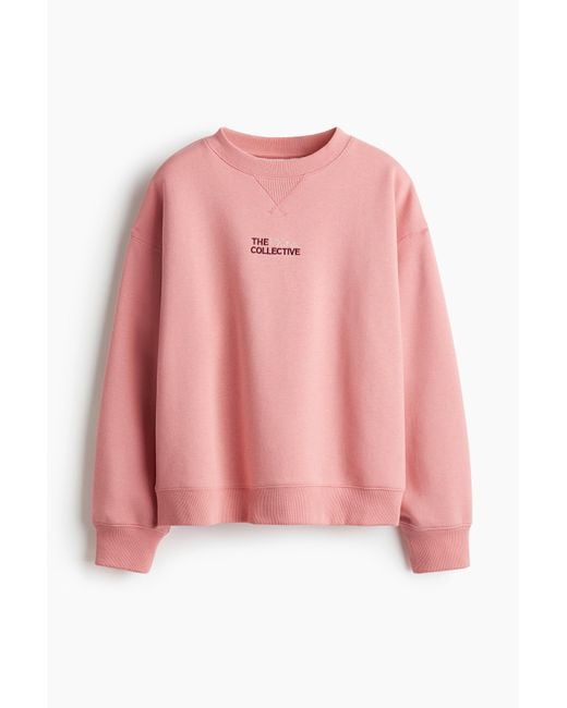 Sweat avec texte H&M en coloris Pink