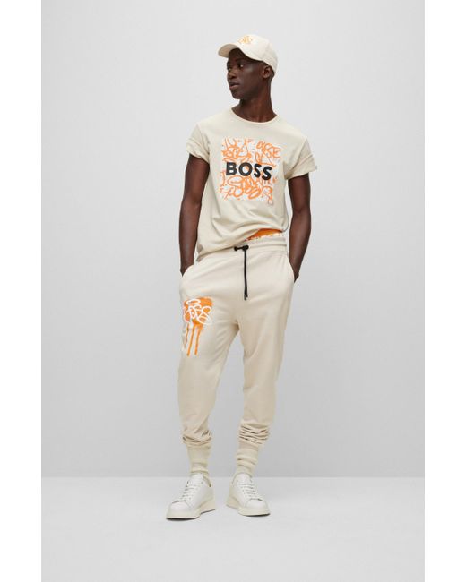 BOSS by HUGO BOSS Cotton Relaxed-fit Tracksuit Bottoms With Graffiti  Artwork in Light Beige (Natural) for Men | Lyst