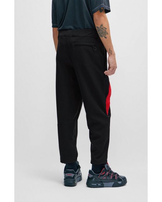 HUGO Relaxed-Fit Jogginghose mit rotem Logo-Tape in Black für Herren