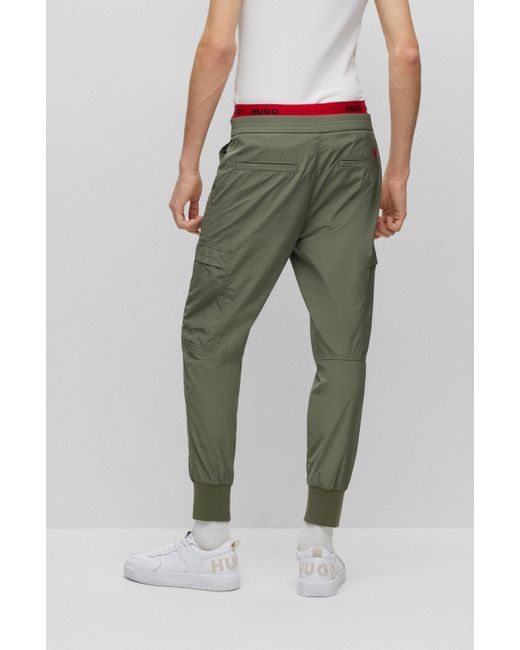 BOSS by HUGO BOSS Slim-fit Cuffed Trousers With Red Logo Label in Green for  Men | Lyst