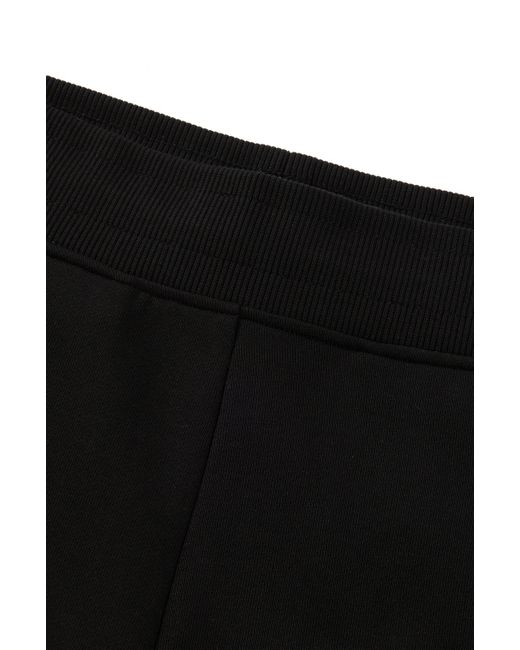 Bas de survêtement en molleton de coton avec logo revisité HUGO en coloris Black