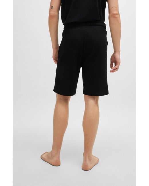 HUGO Shorts aus Baumwoll-Terry mit Logo-Tape an den Seitennähten in Black für Herren